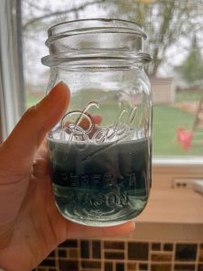 blue mason jar of violet syrup