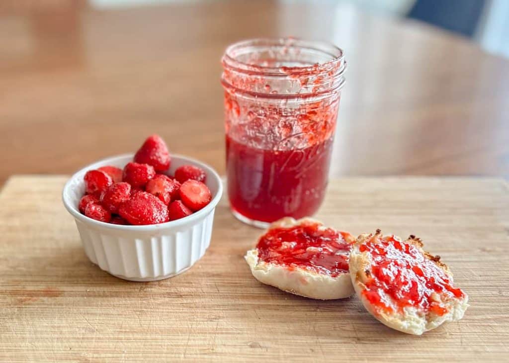 Strawberry jam, toast with jam and a bowl of strawberries
