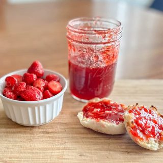 Strawberry jam, toast with jam and a bowl of strawberries