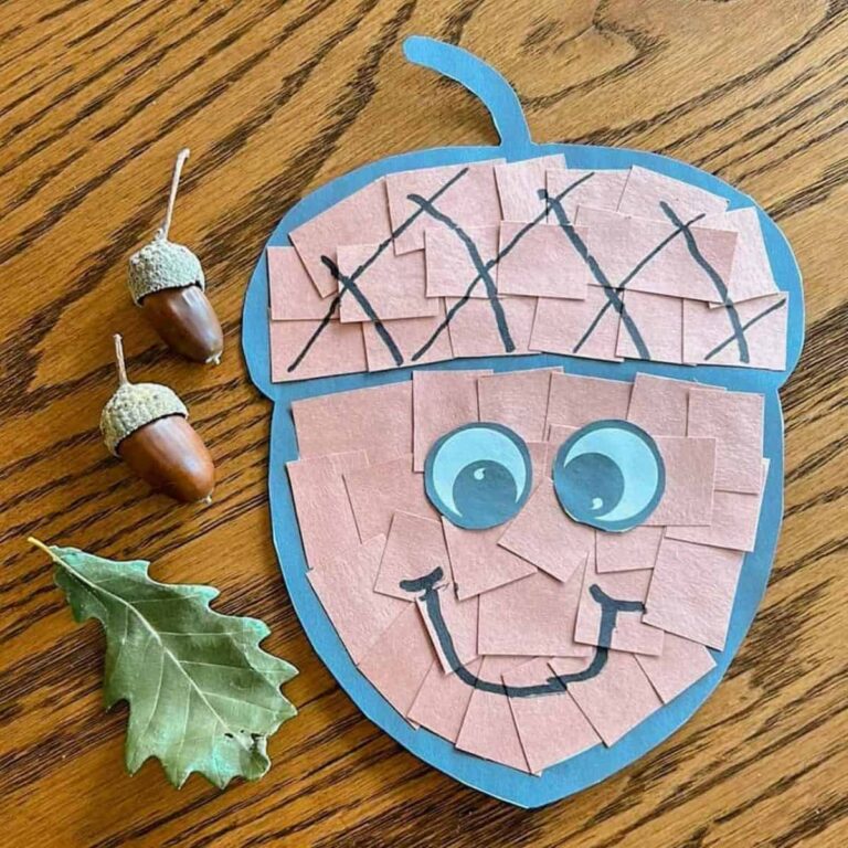 completed acorn craft next to an oak leaf and acorns on a table