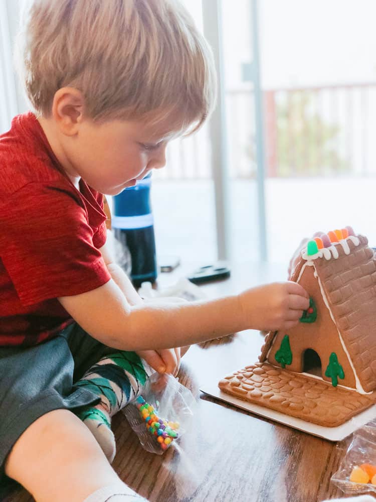 Child making gingerbread house