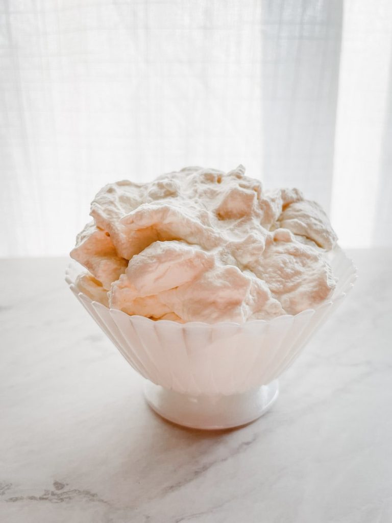 bowl of freshly made whipped cream on a white background