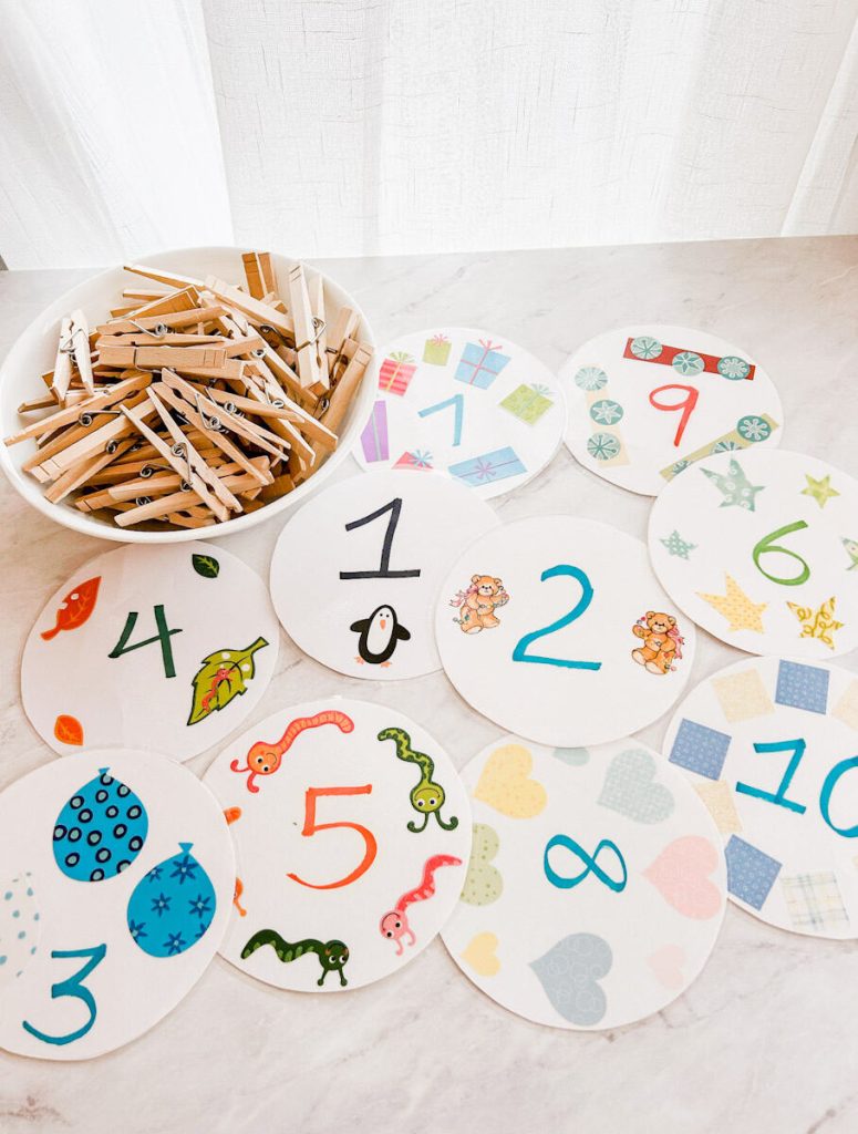 counting cards and clothespins on table