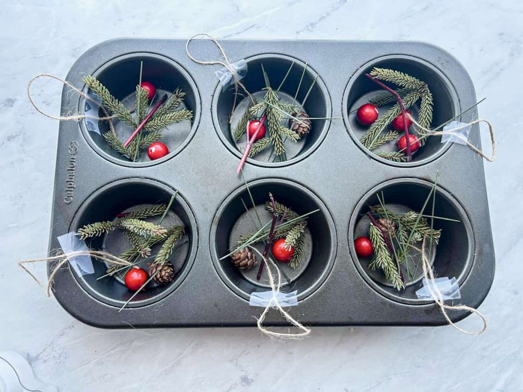 Tin of ornaments with twine taped to side