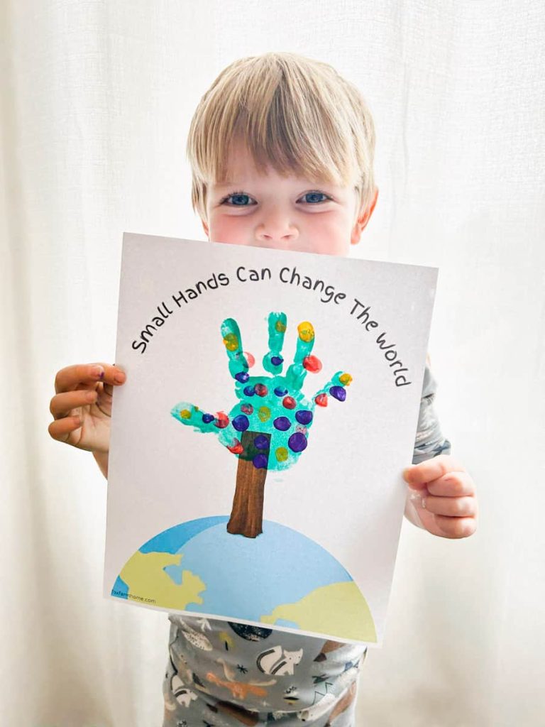 child holding completed hand print earth day printable