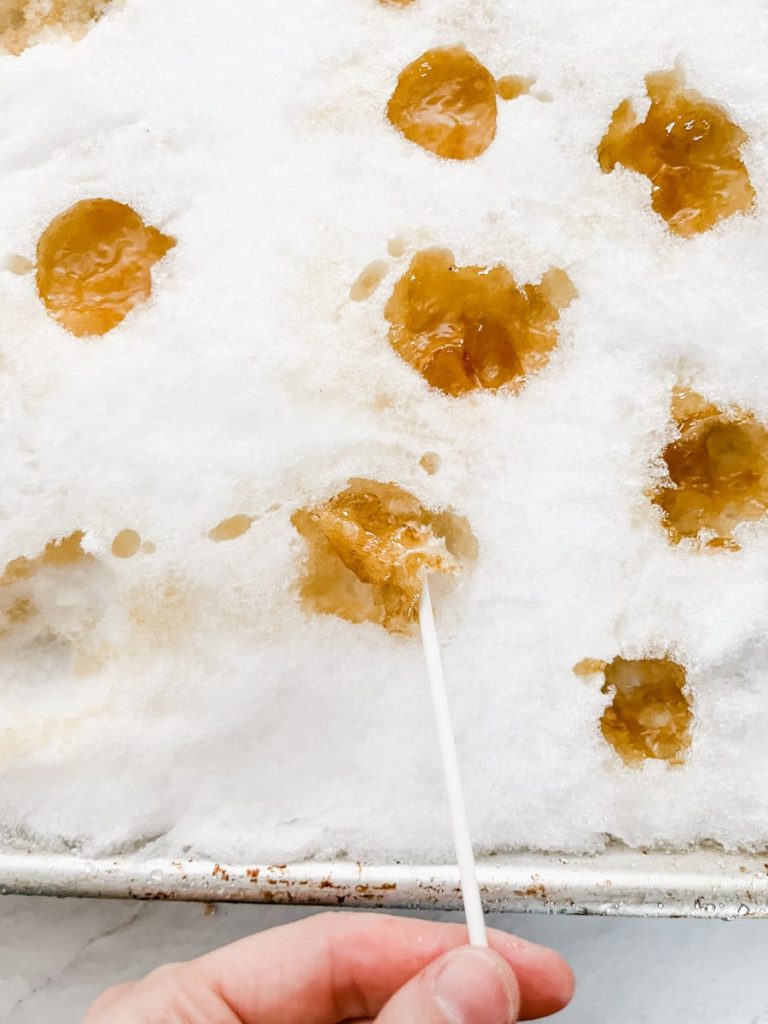 maple syrup snow candy on a pan of snow