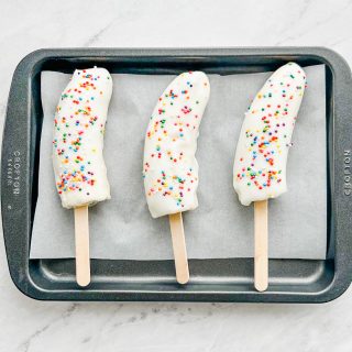 Banana yogurt popsicles on baking sheet