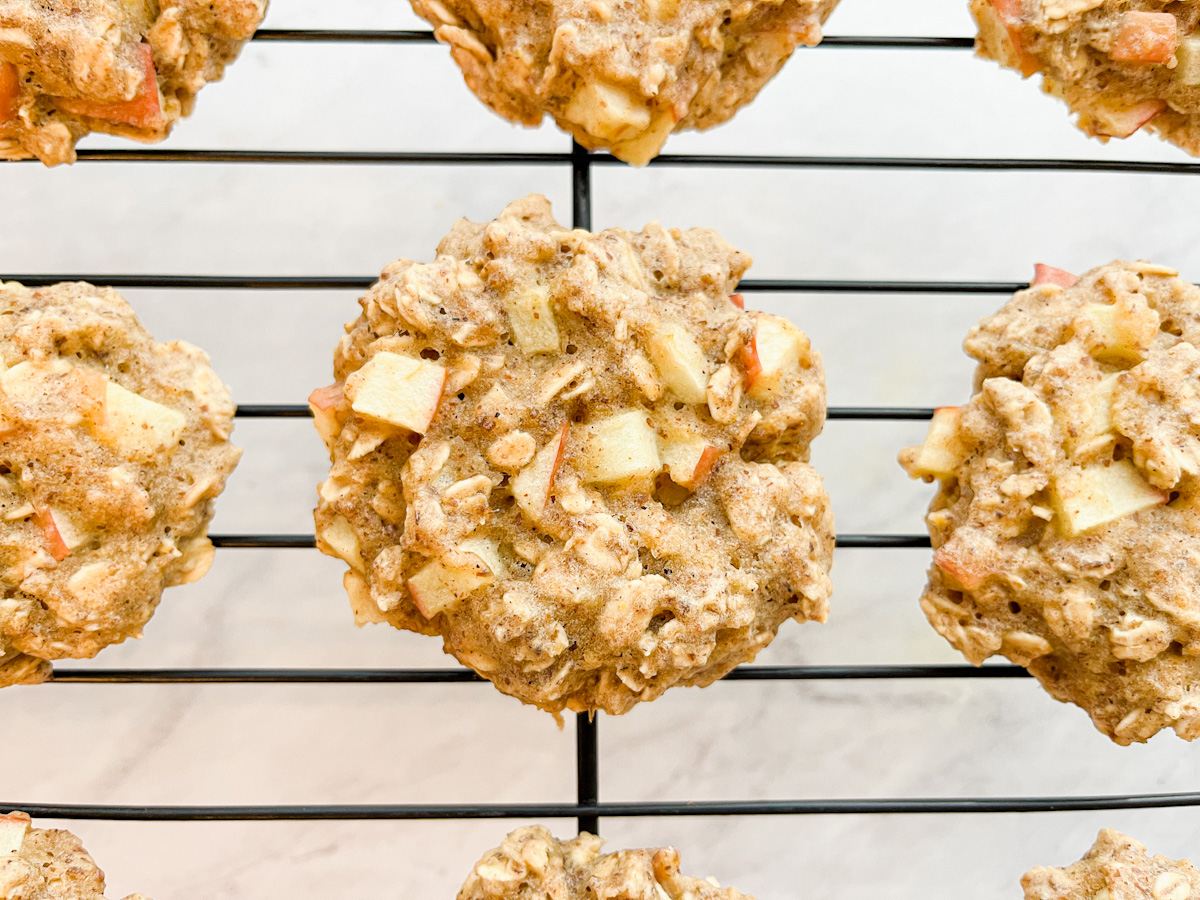 Close up of an apple oatmeal cookie on a wire cooling rack.