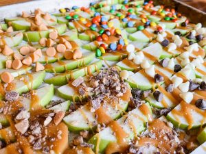 pan of sliced apples with caramel apple toppings