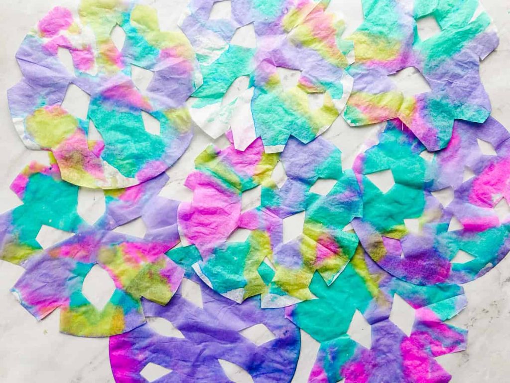 completed coffee filter snowflakes on table