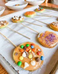 finished caramel apple pops on a baking sheet