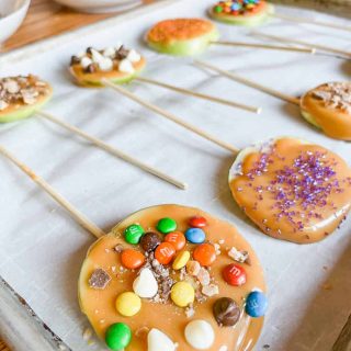 finished caramel apple pops on a baking sheet