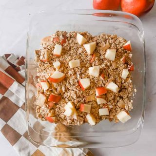 finished overnight oatmeal on table with apples and towel next to it