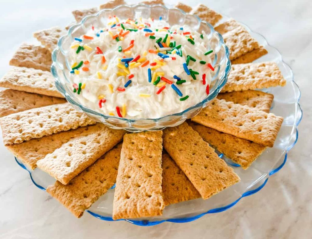 funfetti dip  with graham crackers surrounding the bowl