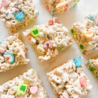 Lucky charms rice krispy bars cut in squares on parchment paper