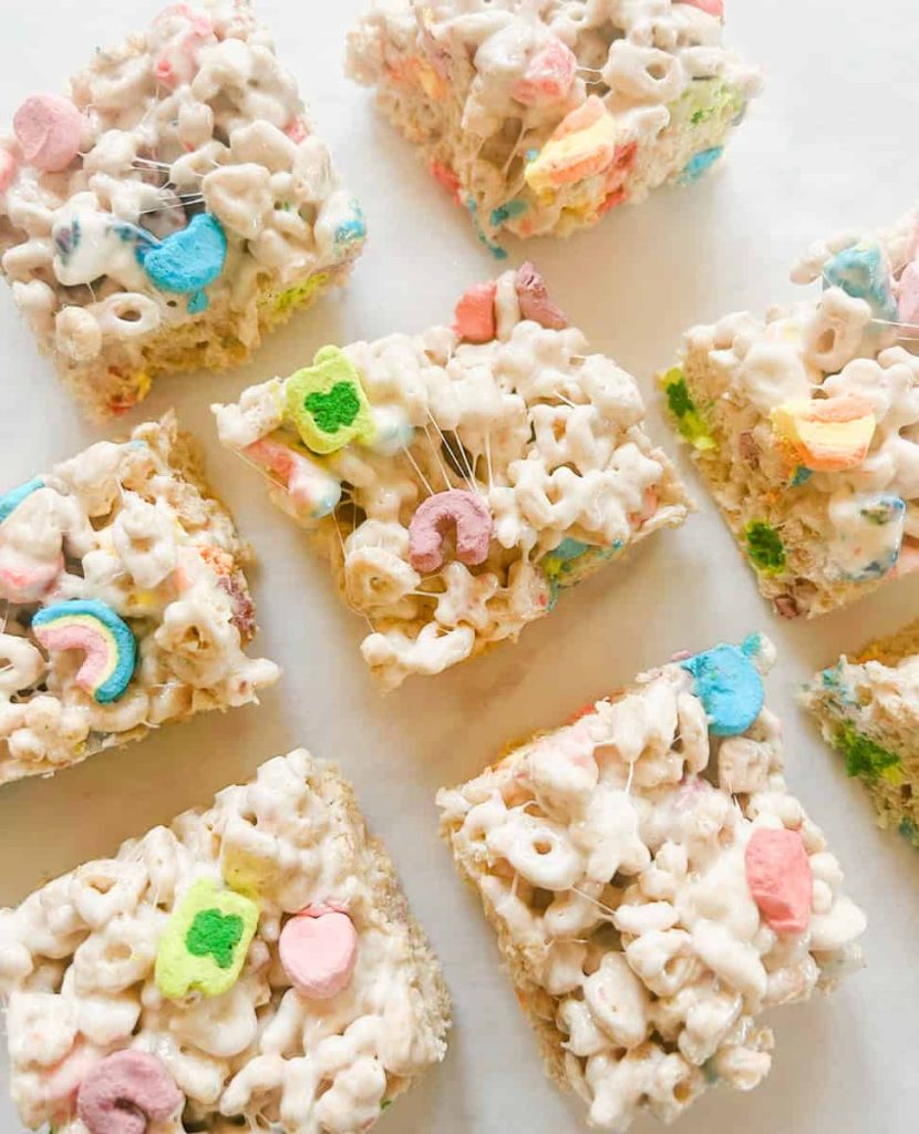 Lucky charms rice krispy bars cut in squares on parchment paper
