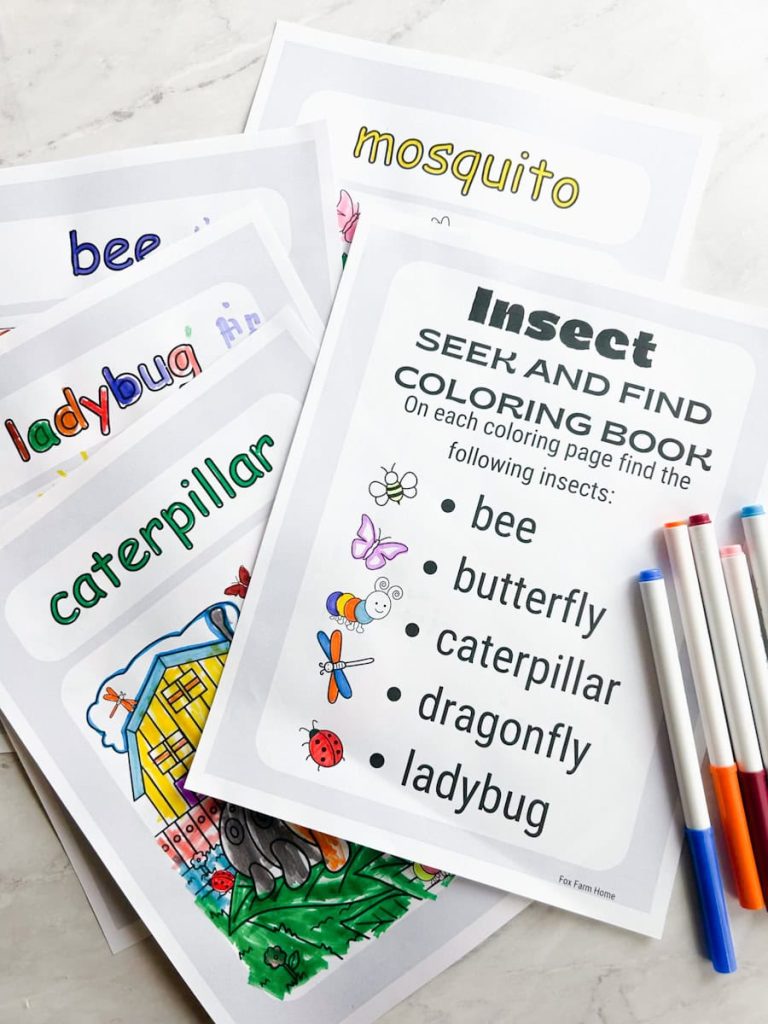 coloring pages spread out on table that have been colored with markers next to it