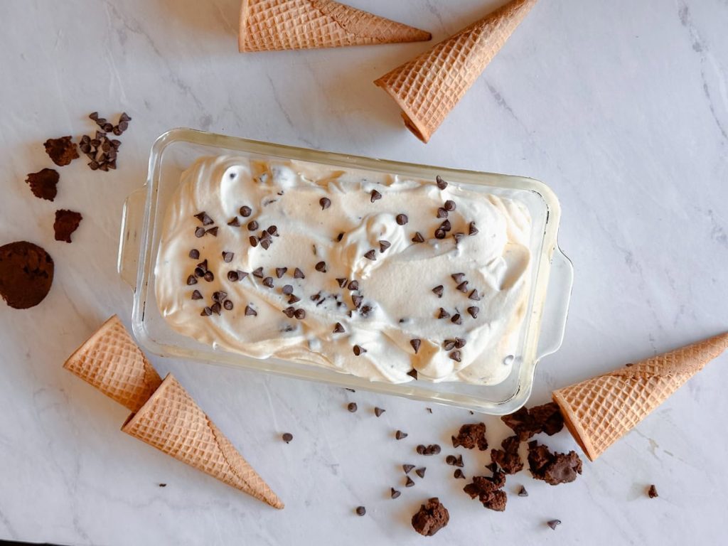 completed ice cream on table with waffle cones on table around it