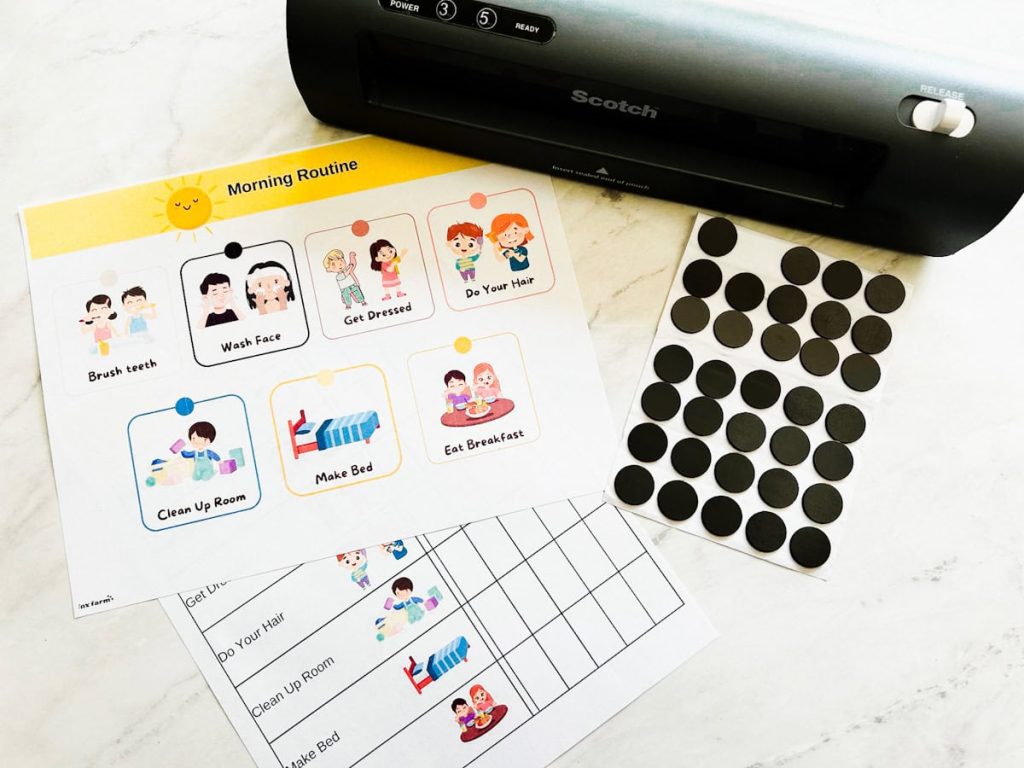 morning routine chart next to laminator and magnetic adhesive dots