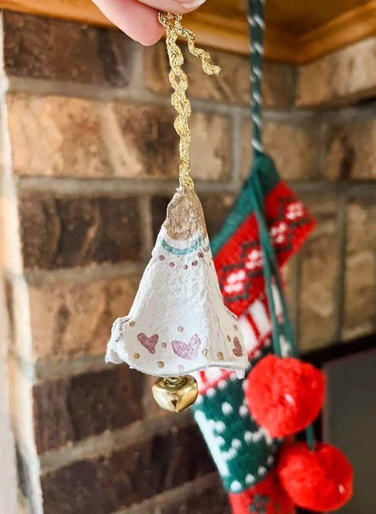 completed egg carton jingle bell hanging on mantle