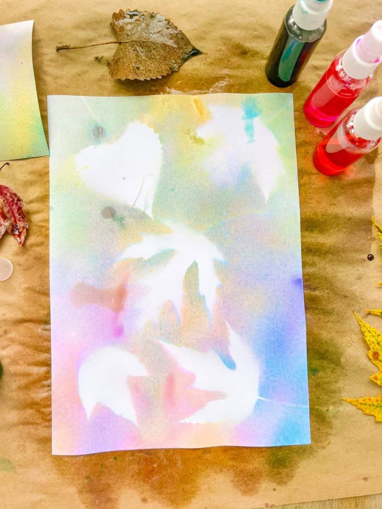 spray painted leaf outlines on a sheet of paper