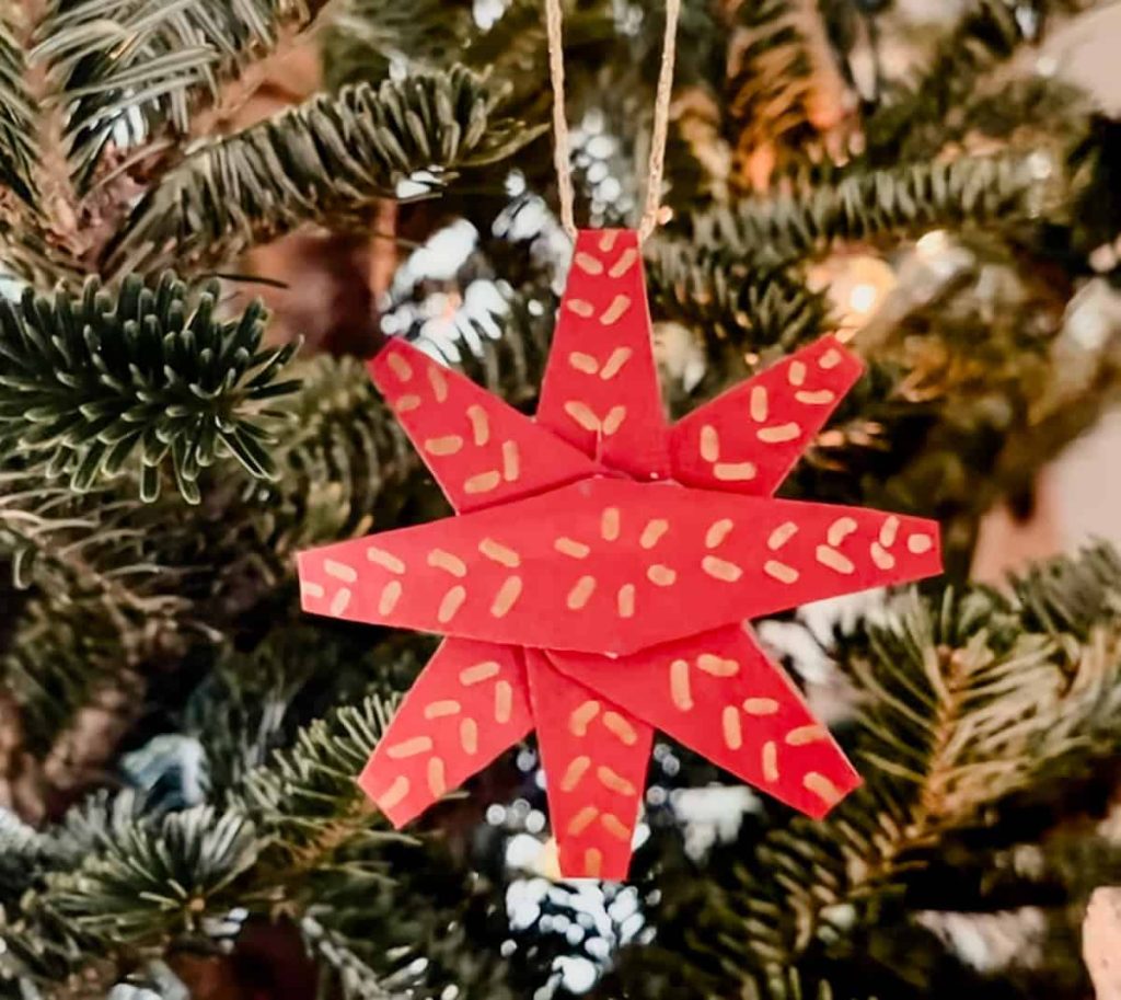 a finished diy christmas star hanging on the christmas tree