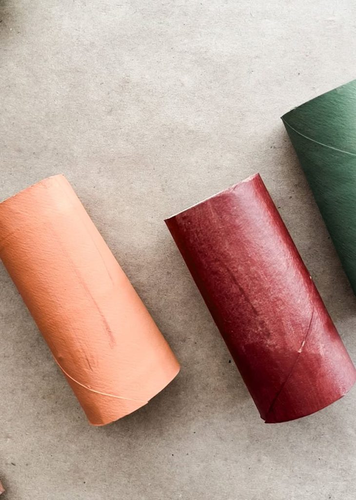 3 painted toilet paper rolls on counter