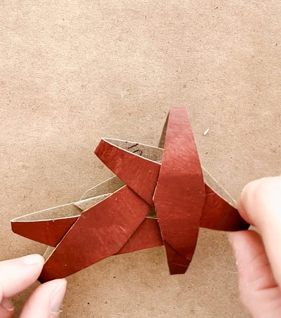 the 2 x shaped tp rolls are being slid into one another to make a star