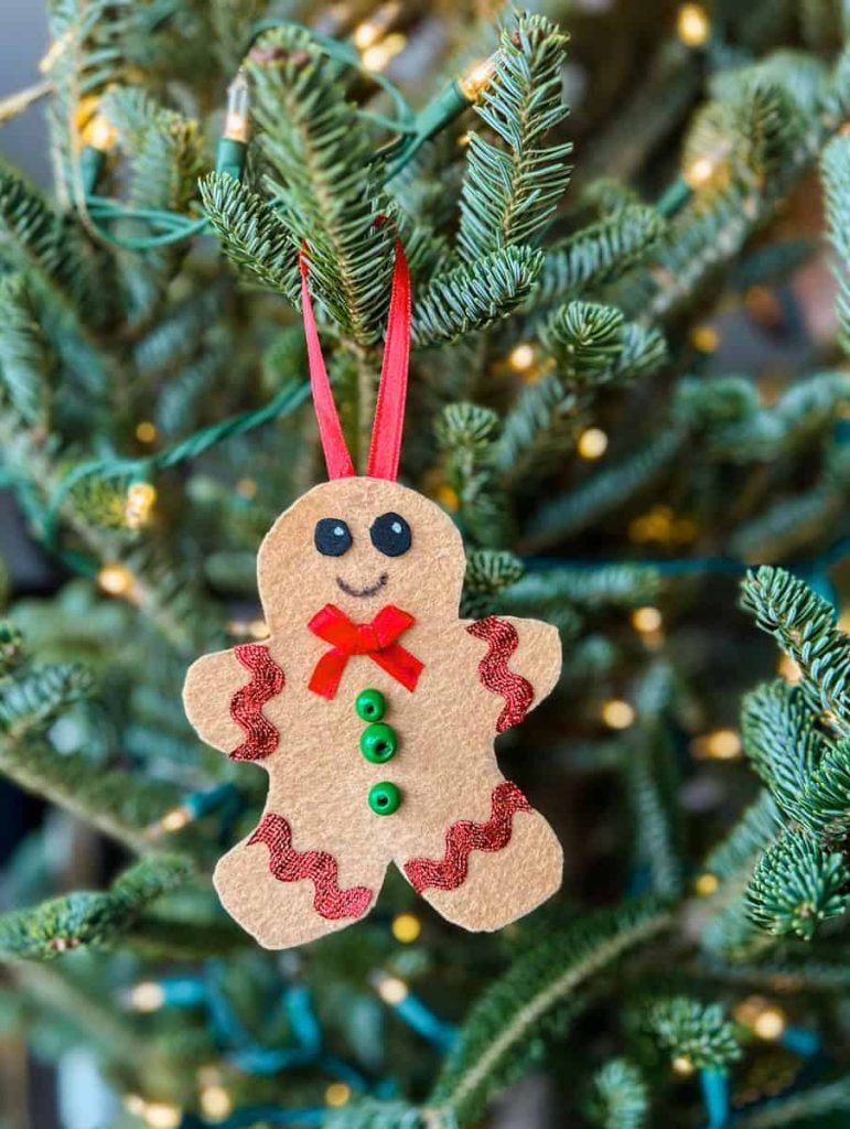 Felt gingerbread man ornament hanging on Christmas tree