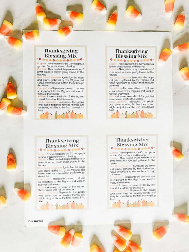 table with free printable tags and candy corn around them