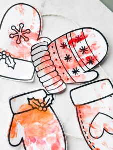 mittens painted and on table and strung with string