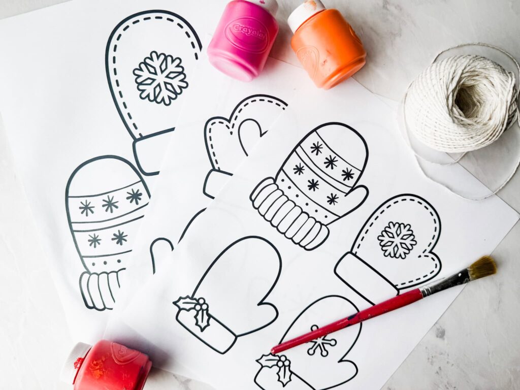 paint, paint brushes, printable mitten templates, and string sitting on table