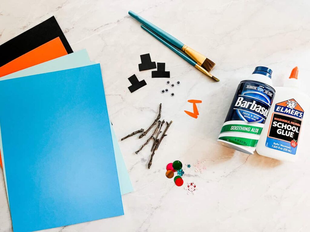all of the materials for melting snowmen craft sitting on a countertop