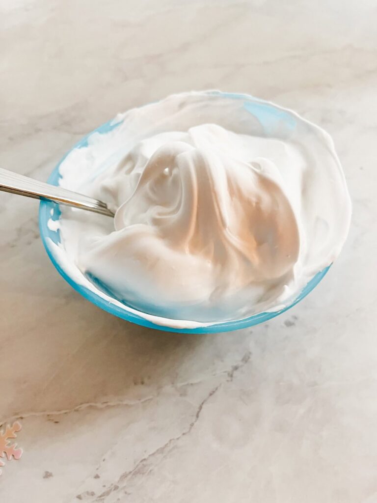 fluffy puffy paint in a bowl with a spoon on the counter