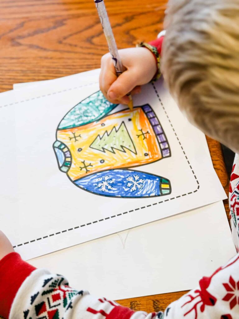 Child coloring their Christmas sweater