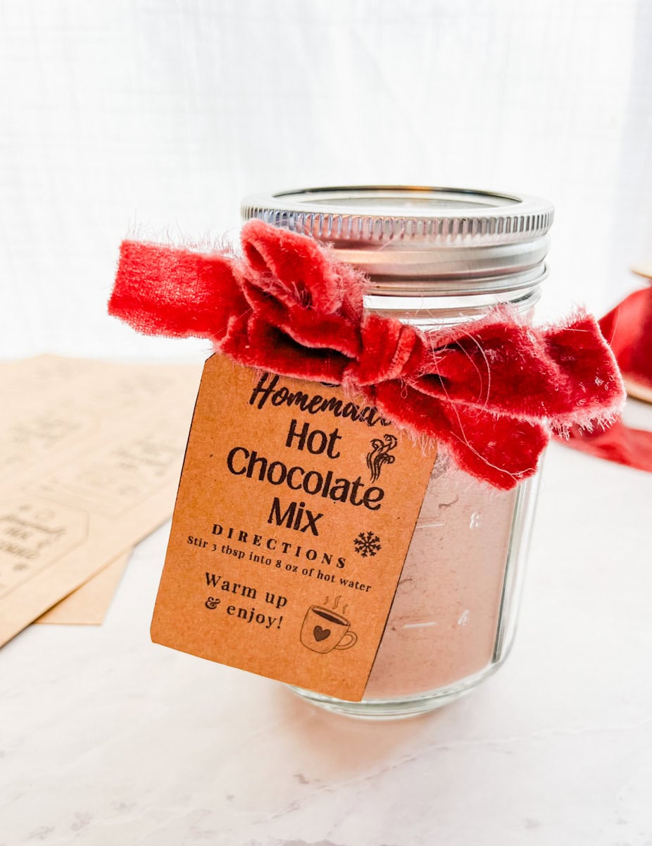 Hot chocolate mix with printable tag and red bow on jar