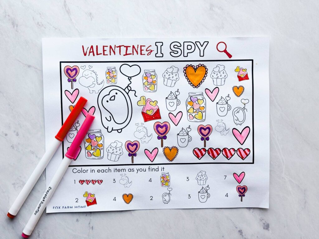 completed I Spy printable game with markers next to it