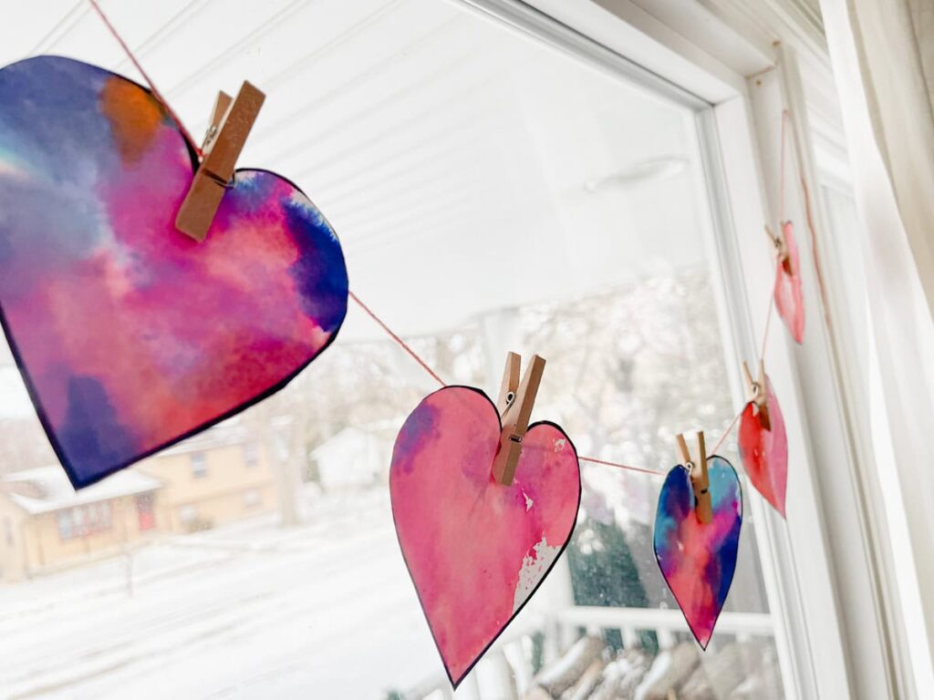 finished heart garland hung in front of the window