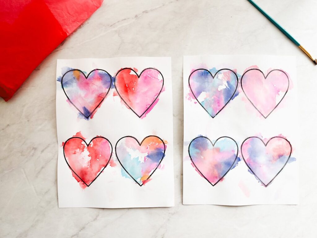 heart templates covered in tissue paper painted on with water