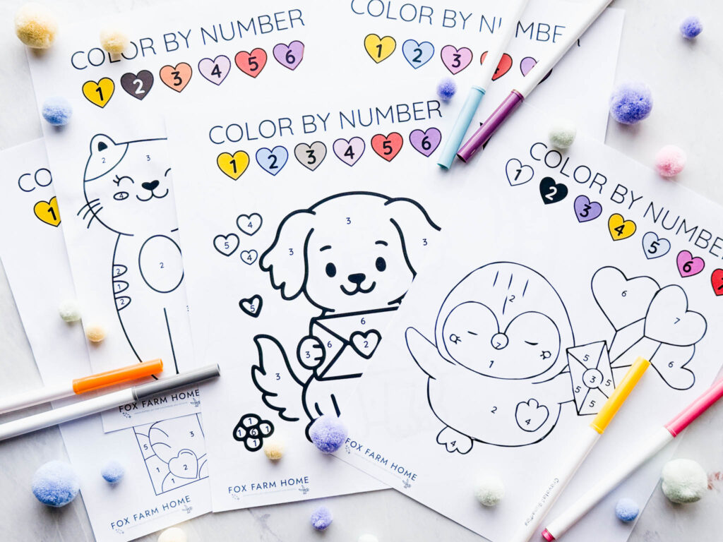 color by number sheets on table with. markers around them