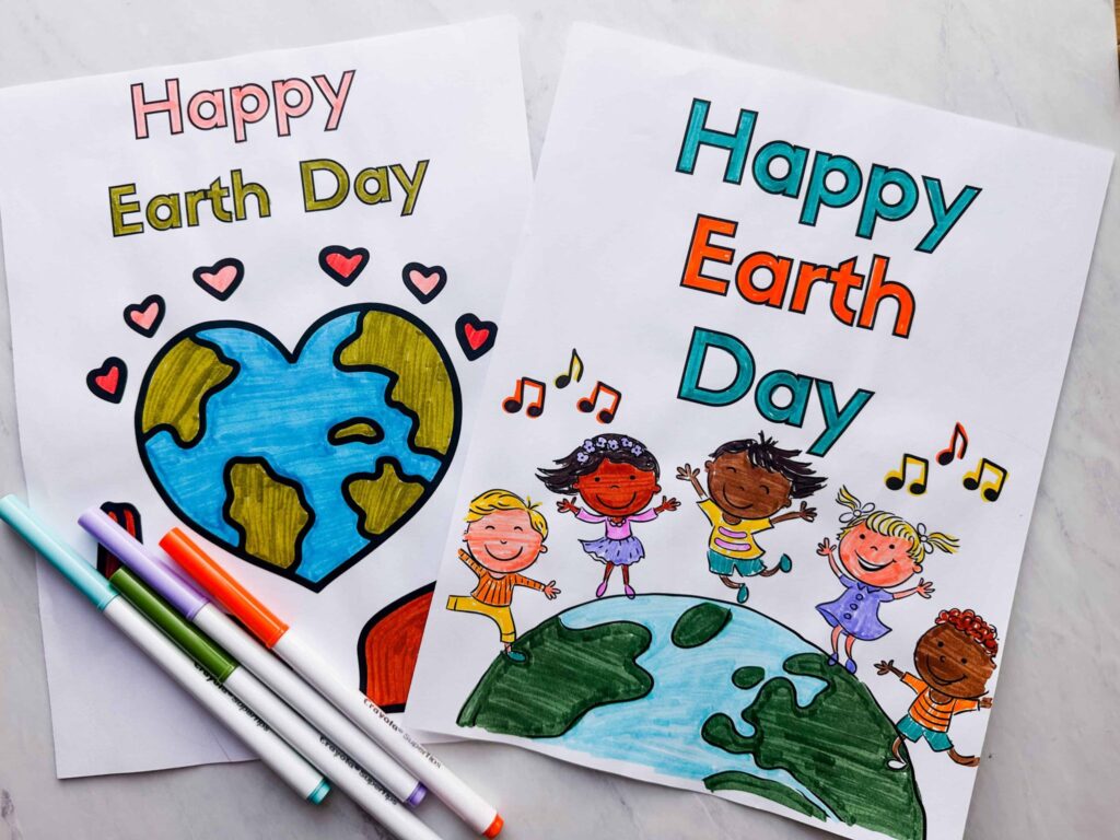 2 completed earth day coloring pages with markers next to them