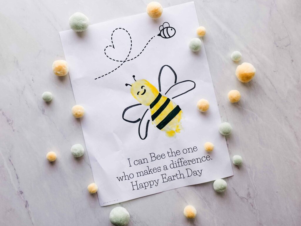 foot print printable Earth Day activity completed with felt balls around it