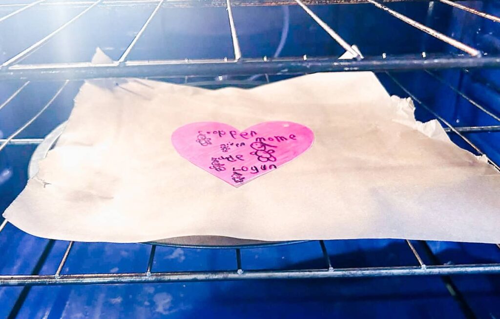 shrinky dink on parchment paper in oven