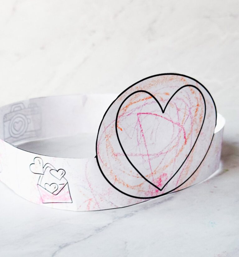 Valentines Day hat on table completed & colored by toddler