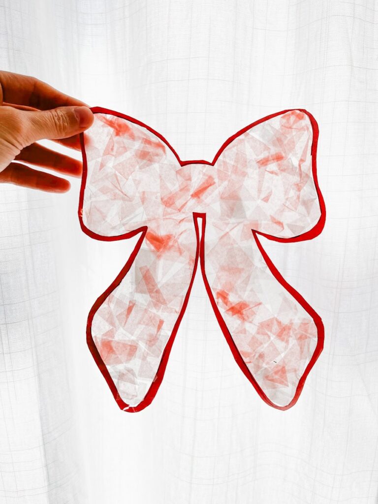 bow suncatcher held up with white background