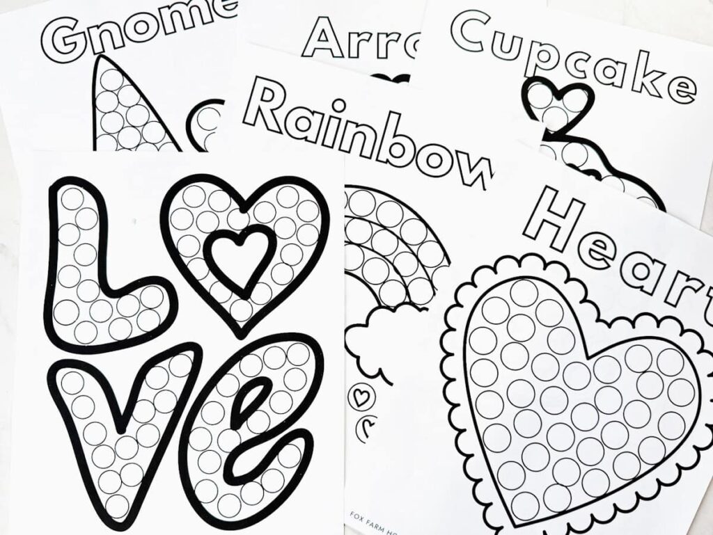 image of the 7 printable dot marker sheets laying on table, not completed