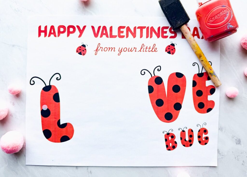 Love bug printable on table with paint and paintbrush