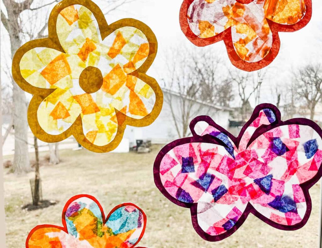 finished butterfly suncatcher and flower suncatcher hanging on a sunny window