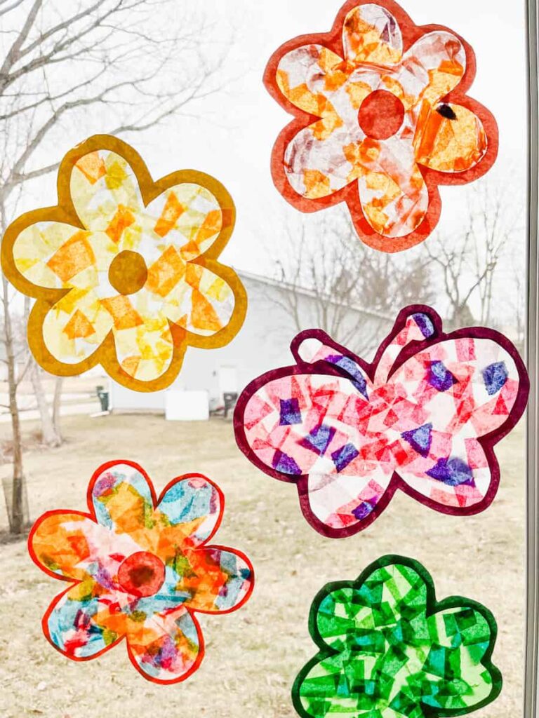 multicolored flower suncatchers and butterfly suncatcher on a window