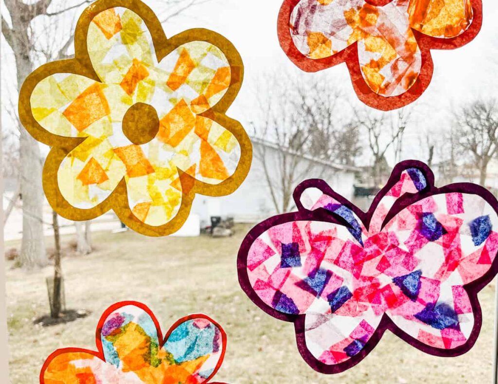 flower suncatchers and butterfly suncatcher hanging on a window